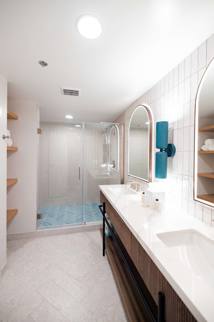 Modern bathroom with double vanity and shower.