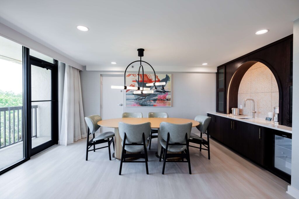 Dining area with chandelier and balcony access.