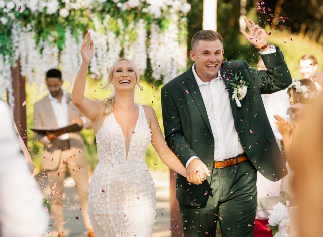 Couple smiling holding hands after saying I do