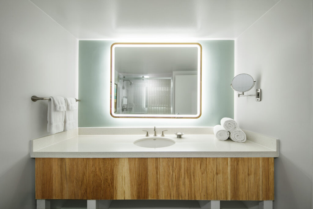 Elegant bathroom vanity with illuminated mirror.