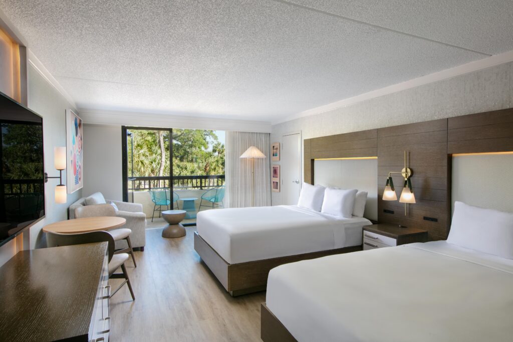 Modern hotel room with two queen beds.