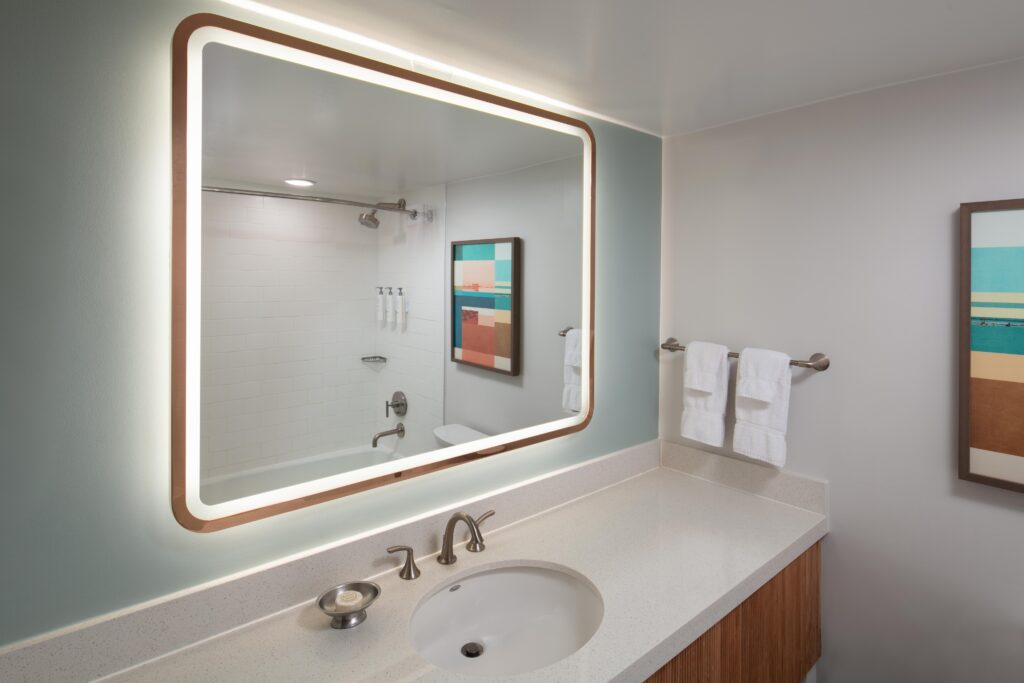 Bathroom with illuminated mirror and modern design.