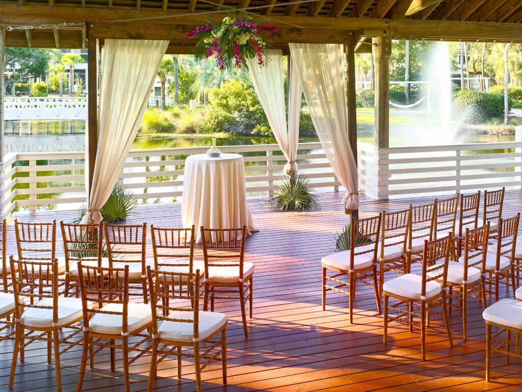 Wooden deck with wedding chairs and altar.