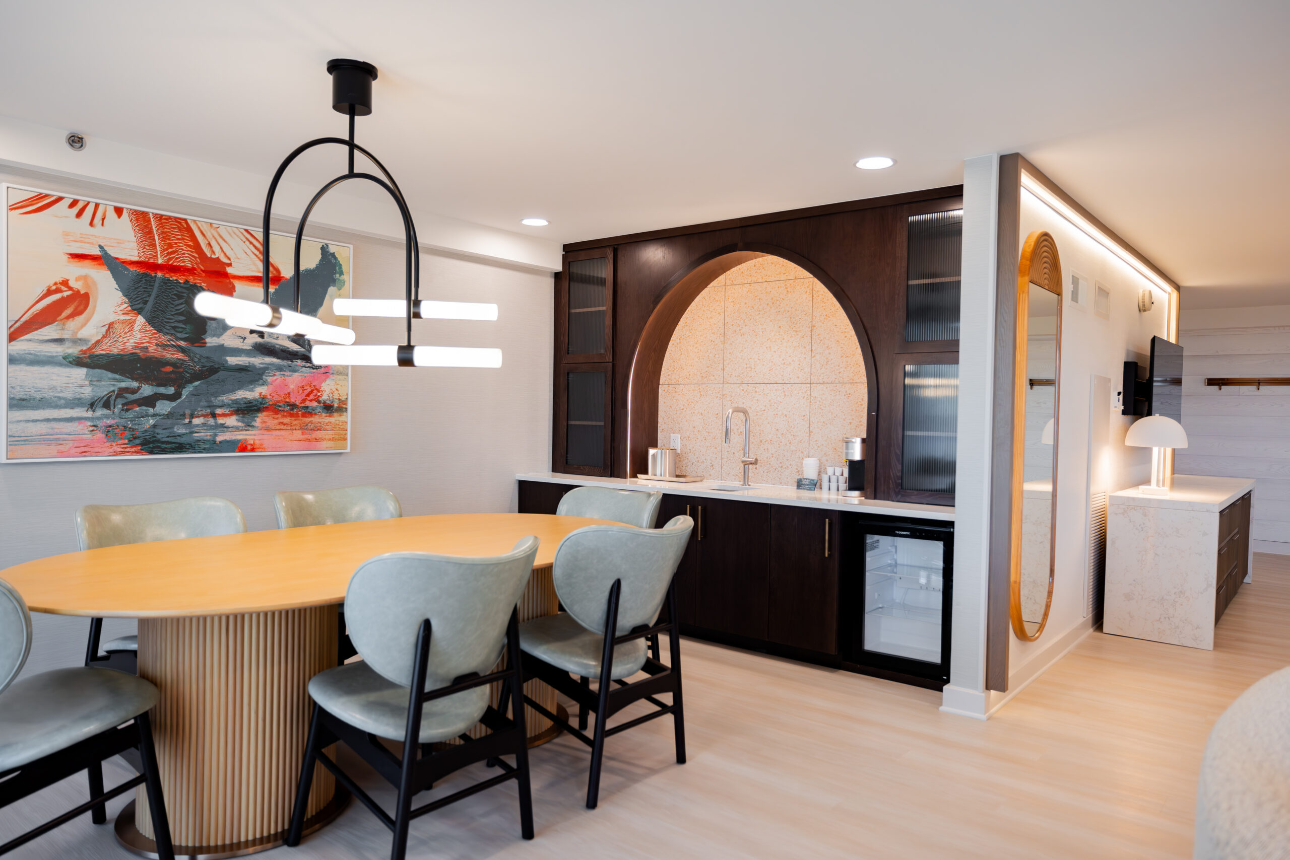 Dining area with kitchenette and unique lighting.