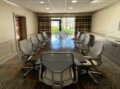 Modern meeting space with natural light and chairs.