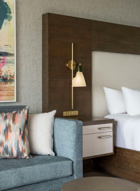 Close-up of cozy hotel bed and nightstand.