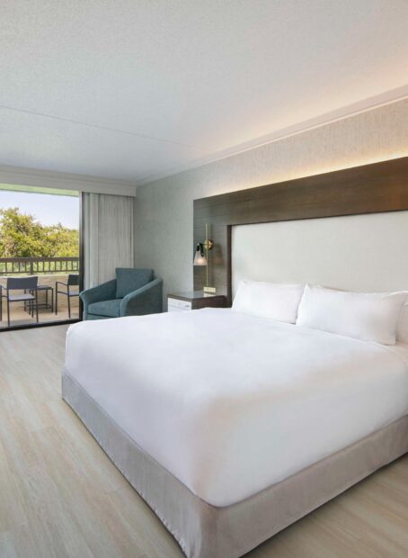 Spacious room with king bed and outdoor view.