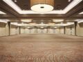 Spacious hotel ballroom with modern chandeliers.