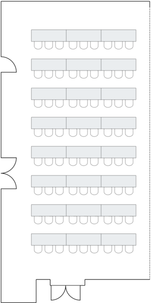 Long room with rows of classroom-style tables.