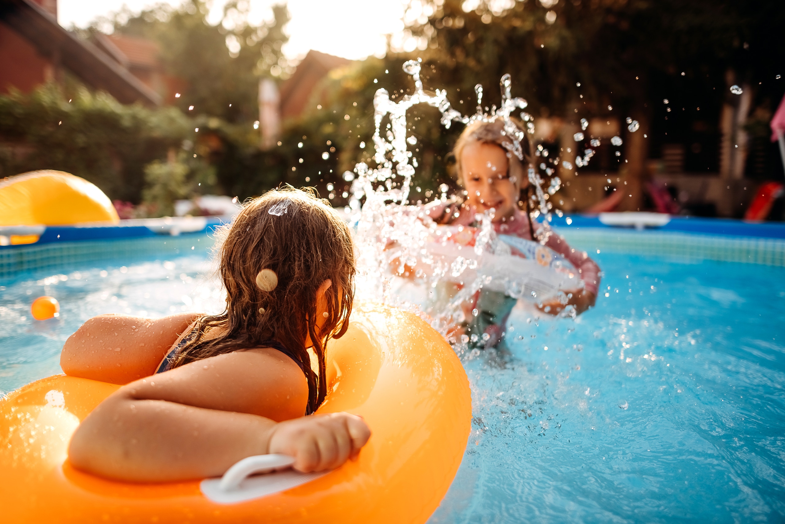 Kids playing in a pool.